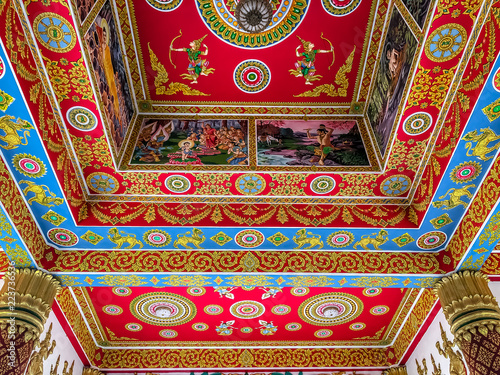 Obraz na płótnie A white staircase with the multi-headed serpant god Naga sitting on the railing. Beside the staircase is a gold statue of a bird. Wat That Phoun, Vientiane Laos w salonie