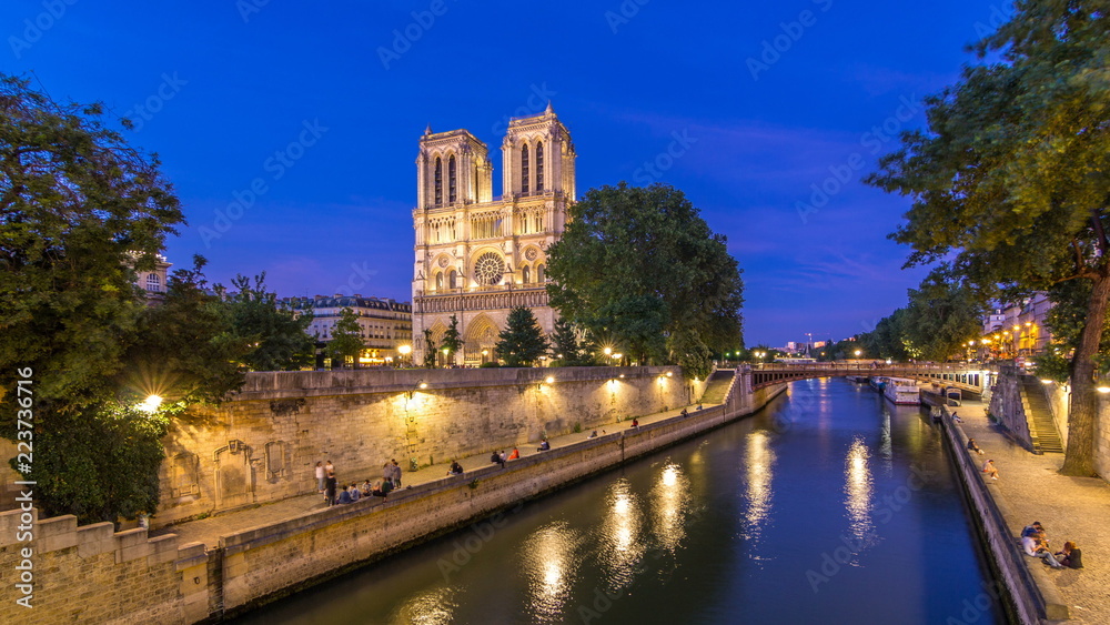Front view of Notre Dame De Paris cathedral day to night timelapse after sunset.