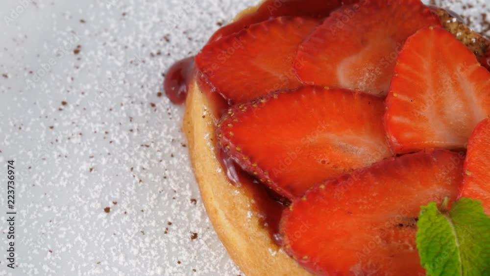 Strawberry dessert, close-up view, with sliced strawberries on top and jam, served in Restaurant, loop Strawberry dessert, close-up view, with sliced strawberries on top and jam, served in Restaurant, loop