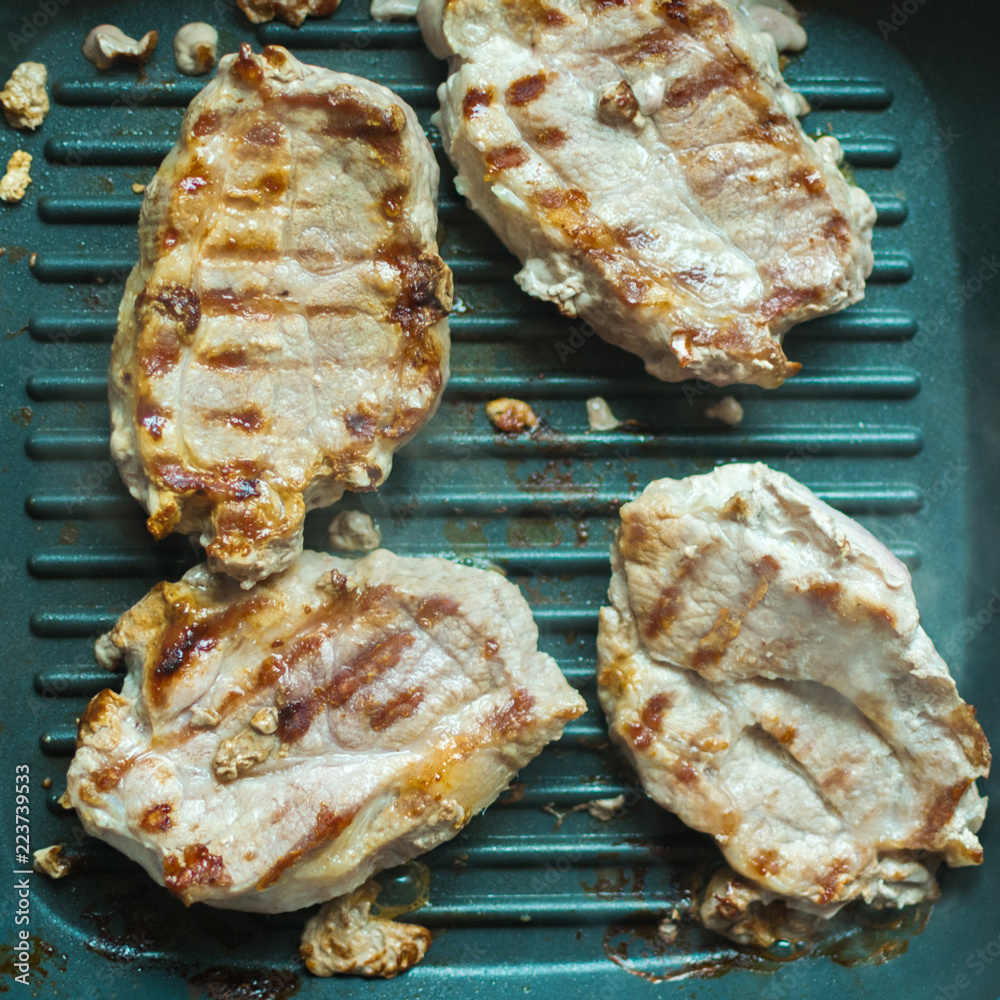 Pieces of roasted meat in a grill. Preparation of meat without oil. Pieces of roasted meat in a grill. Preparation of meat without oil.