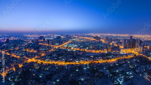 Cityscape of Ajman from rooftop night to day timelapse. Ajman is the capital of the emirate of Ajman in the United Arab Emirates.
