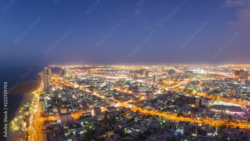 Cityscape of Ajman from rooftop day to night timelapse. Ajman is the capital of the emirate of Ajman in the United Arab Emirates.