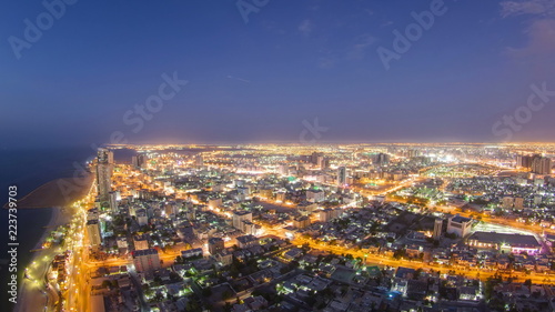 Cityscape of Ajman from rooftop day to night timelapse. Ajman is the capital of the emirate of Ajman in the United Arab Emirates. © neiezhmakov