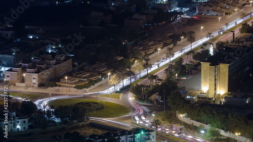 Fototapeta Naklejka Na Ścianę i Meble -  Cityscape of Ajman from rooftop at night timelapse. Ajman is the capital of the emirate of Ajman in the United Arab Emirates.