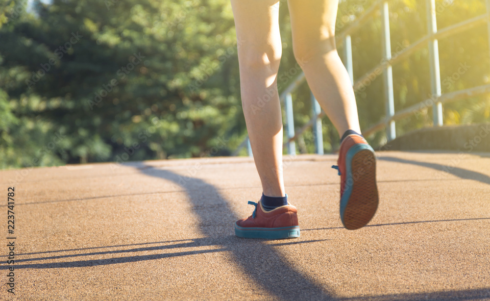 The female walking at the morning for warm up body for jogging and exercise.