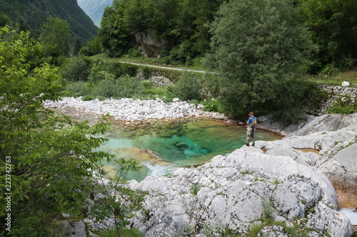 Soca, Slovenia - June 10, 2018: Fishermen fishing trouts in lepena valley photo