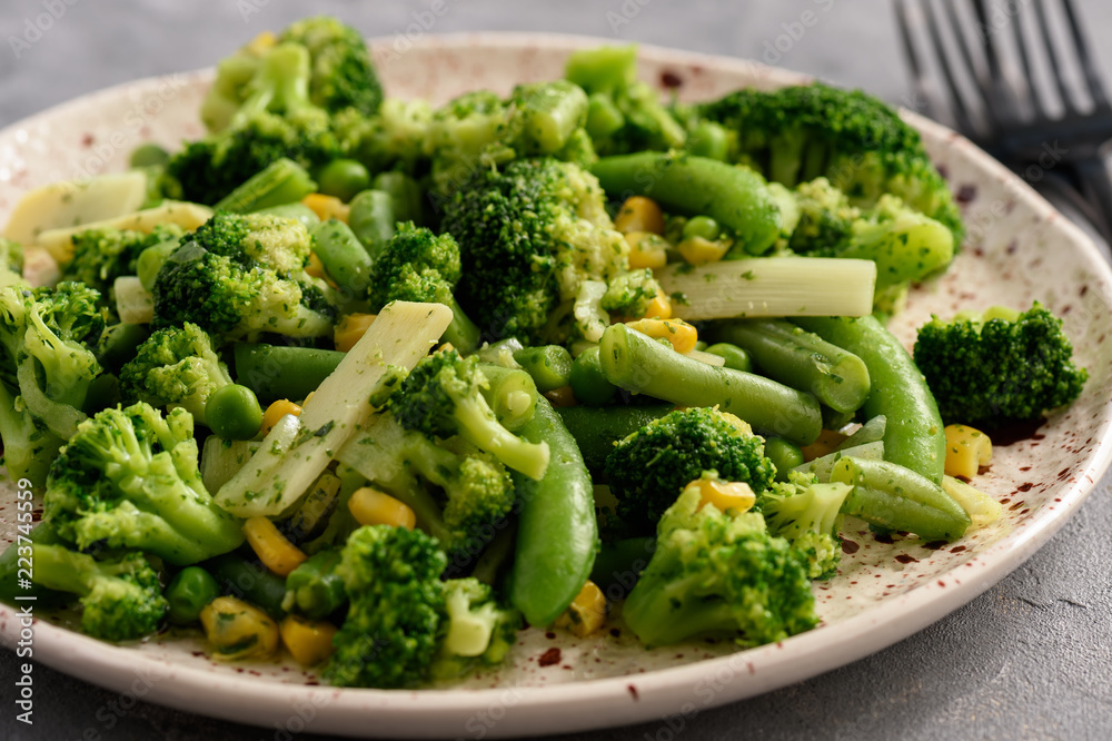 Cooked green vegetables as broccoli and green bean.