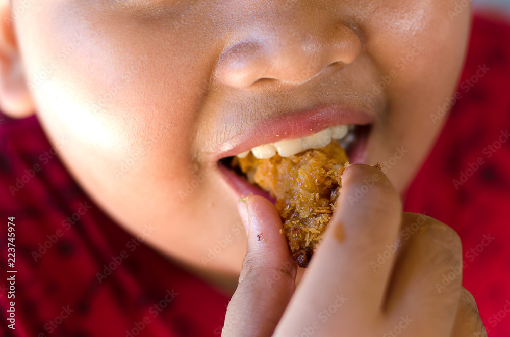 Obese children are happily eating fried chicken Obese children are happily eating fried chicken