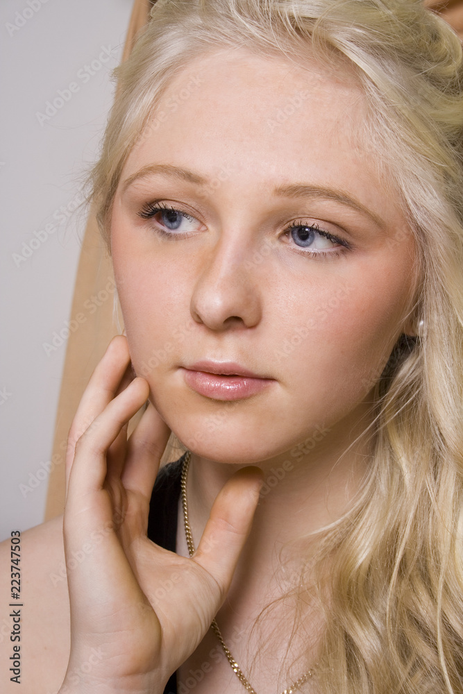 portrait of a young beautiful girl with blue eyes and blonde hair daydreaming in her boudoir portrait of a young beautiful girl with blue eyes and blonde hair daydreaming in her boudoir