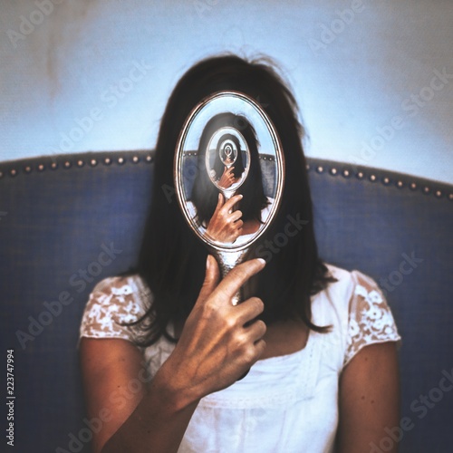Infinite reflection of woman in mirror