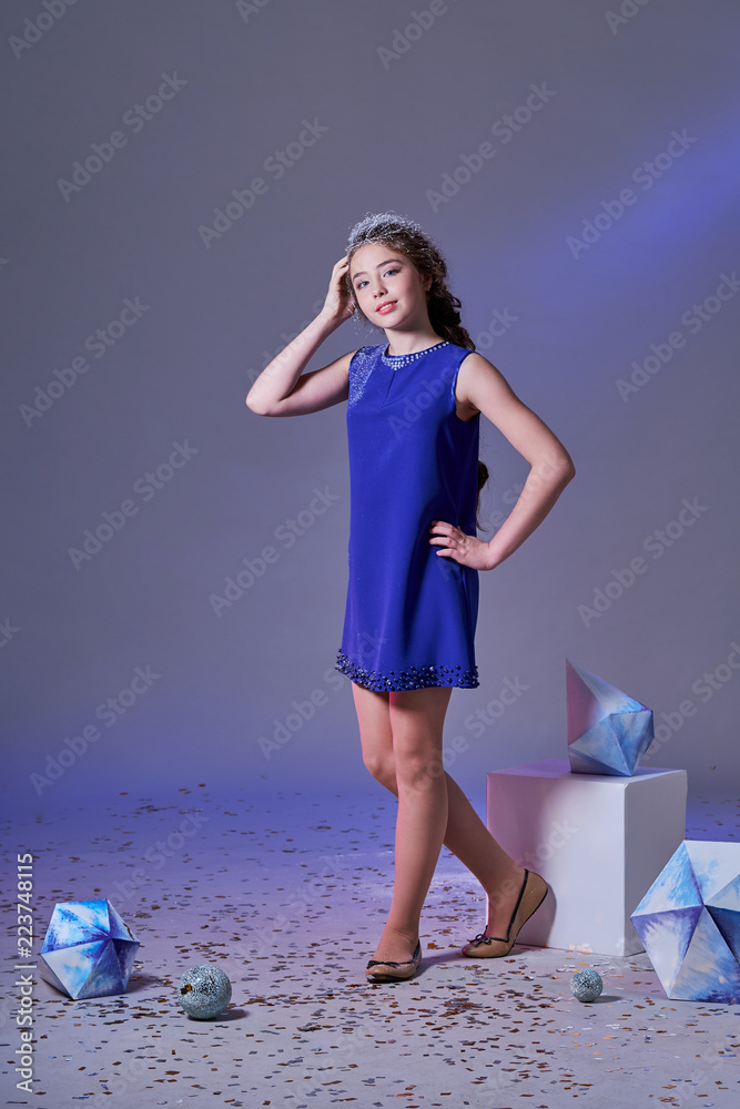 Elegance blue dresses for girls teenager. Fashion lady style, designer  collection. Beautiful lady female posing catalog clothes. Young beautiful  model woman adolescent in studio shot, gray background. Stock Photo