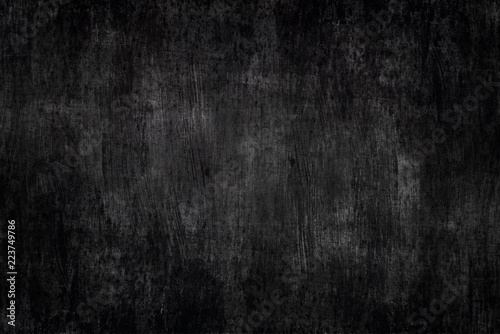 a black painted metal background with brush strokes