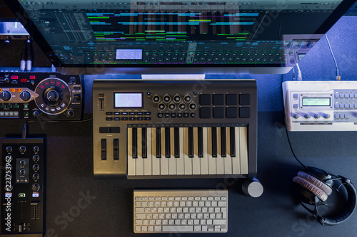 Professional home music record studio, dj and producer equipment on the black desk workplace. Technology of electronic sound production and audio recording. Flat lay top view