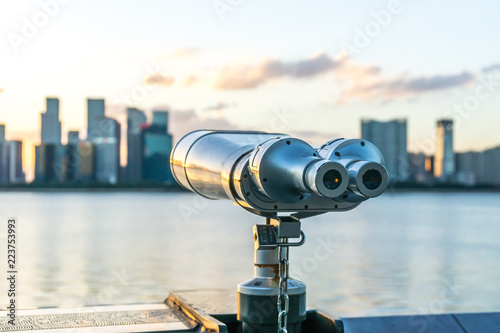 telescope with city skyline