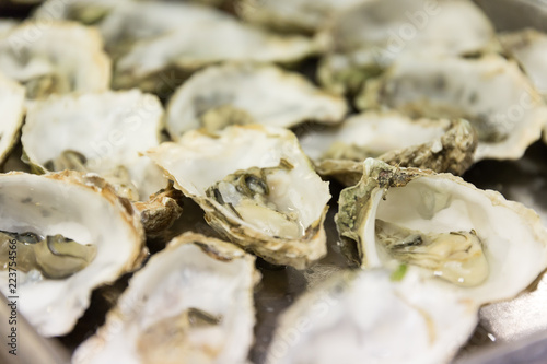 A plate of Oysters in a restaurant kitchen.