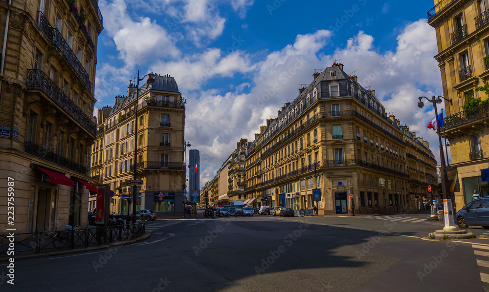 Fototapeta premium Crossroad of streets of Paris without tourists with a beautiful architecture and cloudy sky (Saint-Germain, 6th district)