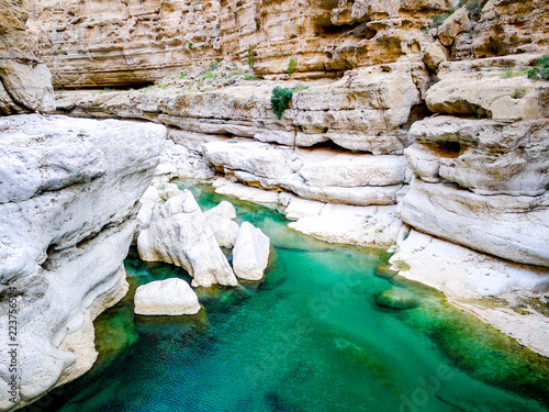 Bright, turquoise blue waters of Wadi Shab, a canyon near Muscat in Oman