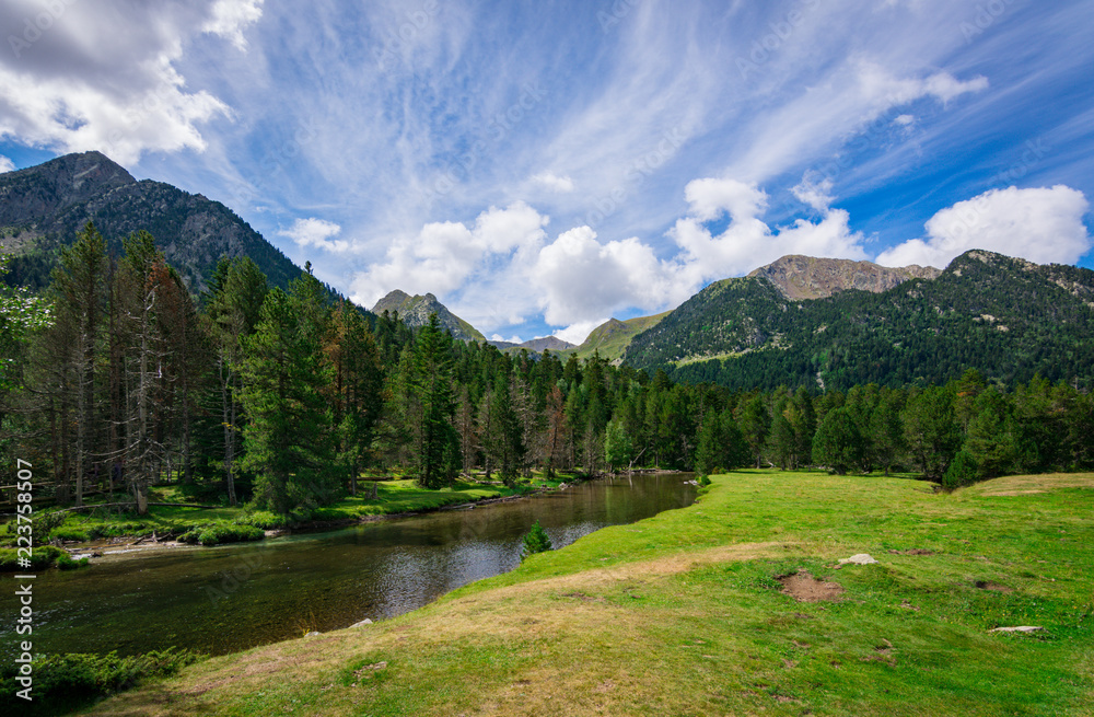 View of the meadows and peaks of the Aiguestortes National Park, Lleida, Pyrenees, Catalonia