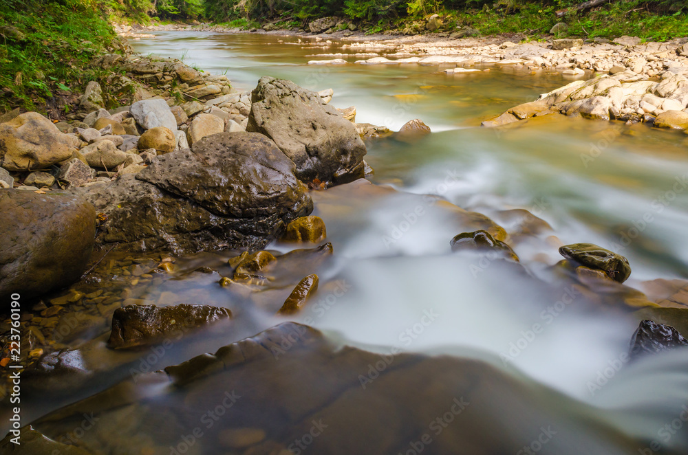 The waterfall on the long exposure in the Carpathian Mountain The waterfall on the long exposure in the Carpathian Mountain