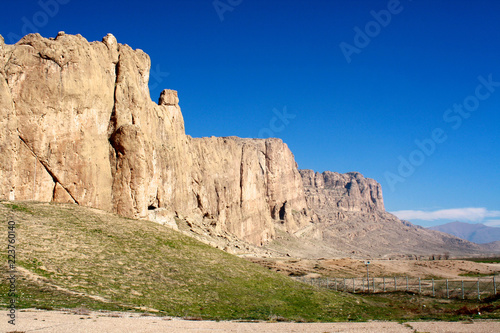 Dramatic sandstone cliffs and clear blue skies near Naqsh-e Rustam in the Fars region of southern Iran