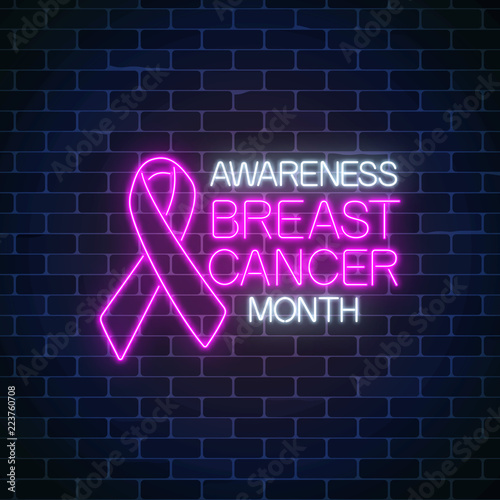 Glowing neon sign of breast canser awareness month in october. Neon poster design with pink ribbon