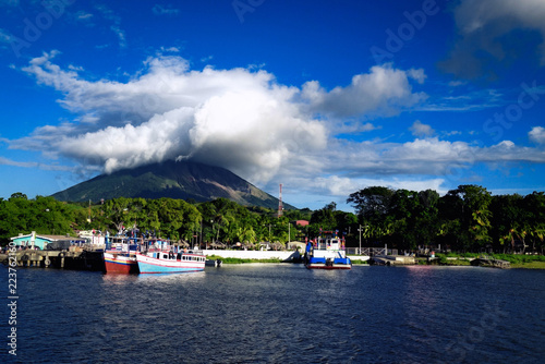OMETEPE, NICARAGUA - Dec 2015: Moyogalpa port on Ometepe Island in Lake Nicaragua with fishing boats and cloud-topped Concepcion volcano in the background photo