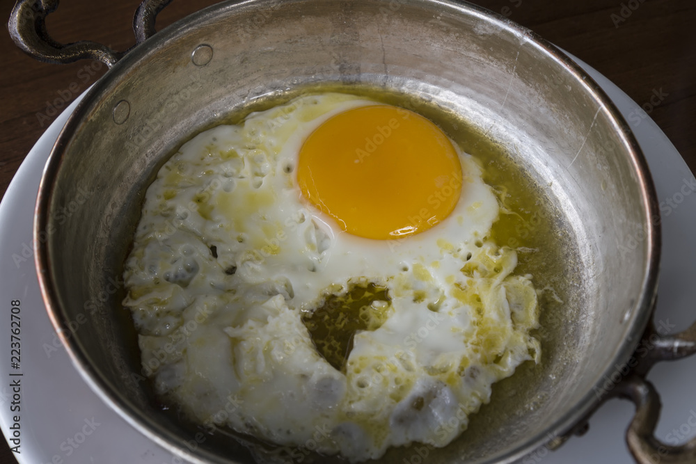 omelette in the copper pan for breakfast. omelette in the copper pan for breakfast.