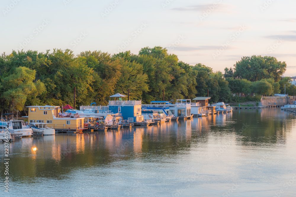 Twilight image of Mississippi River from Raspberry Island. sunset with house boats, tree lined smooth river scene