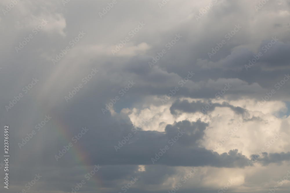Expressive cloudscape with rainbow after rain