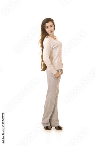 Emotions of a beautiful girl with long hair, in a white jacket posing in Studio on a white background.