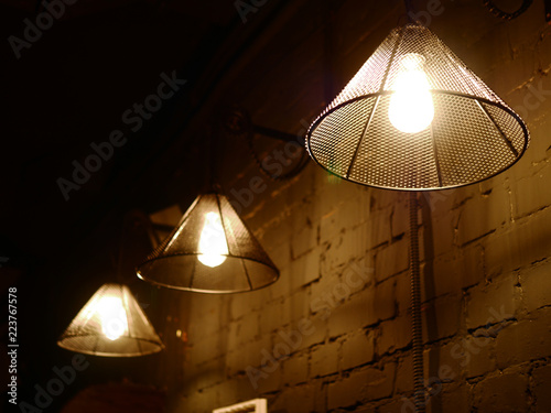 Vintage lighting lamp hang in front of cement brick wall at loft