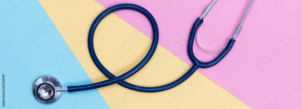 Stethoscope on pastel colored paper texture Stethoscope on pastel colored paper texture