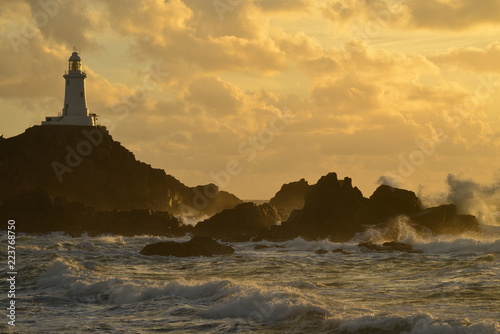 Corbiere lighthouse, Jersey, U.K. Coastal landmark in Autumn with stormy Atlantic seas.