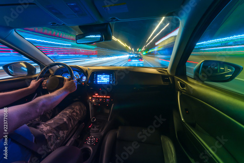 Movement of the car at night at a speed view from the interior, Brilliant road with lights with a car at high speed © narozhnii