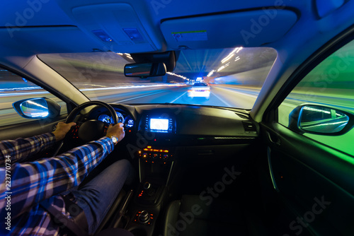 Movement of the car at night at a speed view from the interior, Brilliant road with lights with a car at high speed © narozhnii