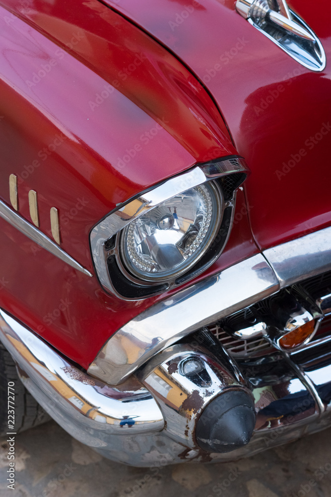 Trinidad, Cuba - Jul 7 2018: Chrome headlight of old timer car on Trinidad street