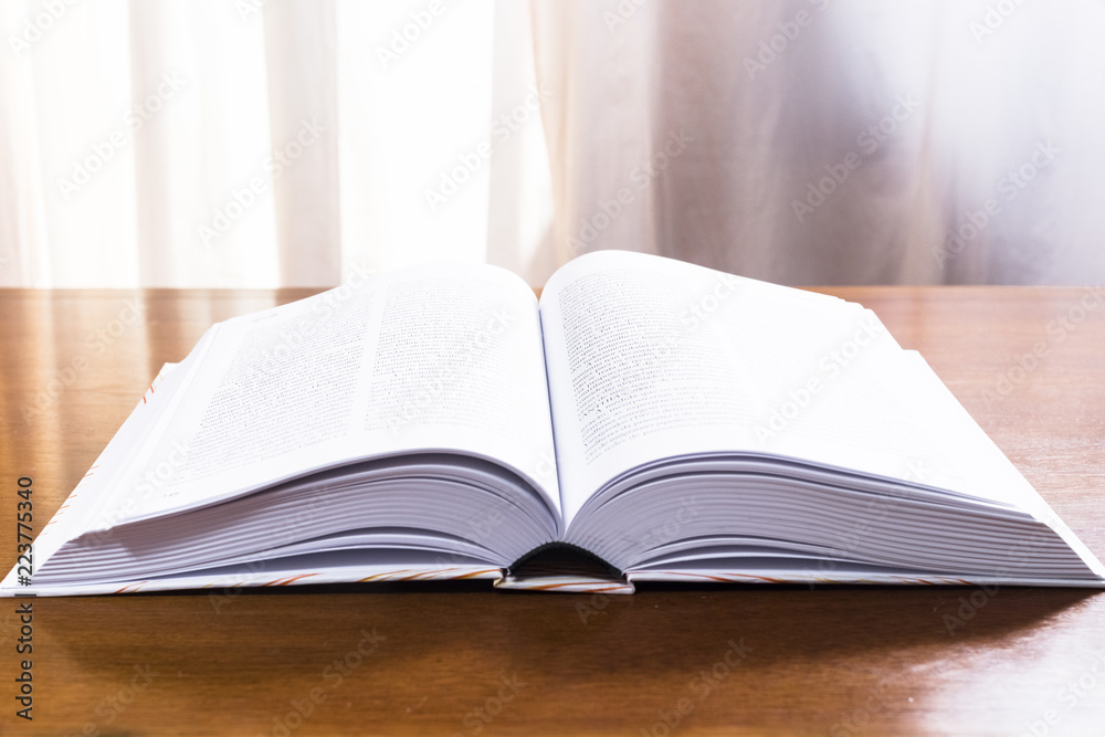 Hard cover books organized over wooden table Hard cover books organized over wooden table