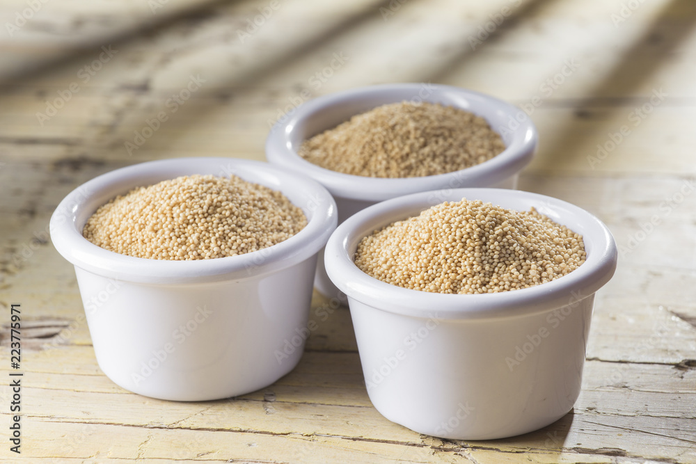 amaranth beans in bowl, on rustic wooden background amaranth beans in bowl, on rustic wooden background