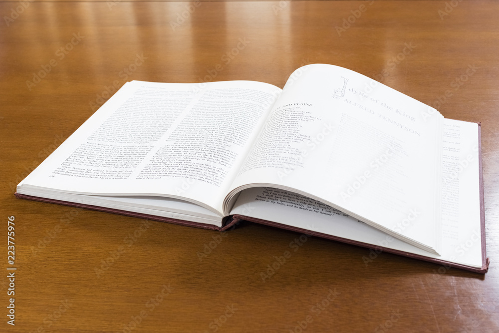 Hard cover books organized over wooden table Hard cover books organized over wooden table