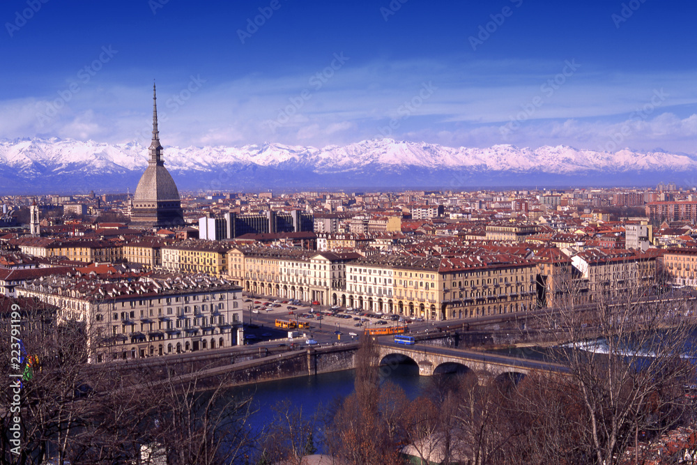 Turin, Piedmont, Italy skyline of the city with building symbol Mole Antonelliana, Po river and snowy Alps on backgound.