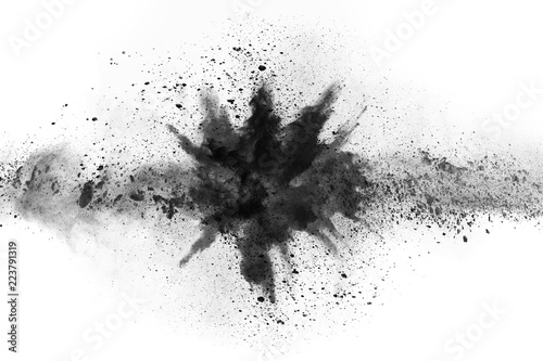 Obraz na płótnie particles of charcoal on white background,abstract powder splatted on white background,Freeze motion of black powder exploding or throwing black powder
