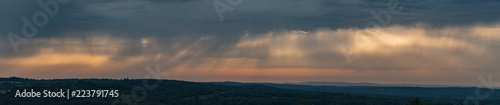 Stunning panoramic image of Summer sunset sky with colorful vibrant cloud formations