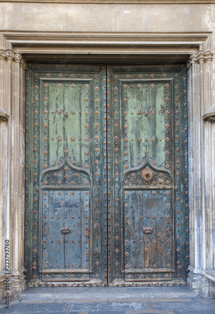 Old massive church door of the catholic church Old massive church door of the catholic church