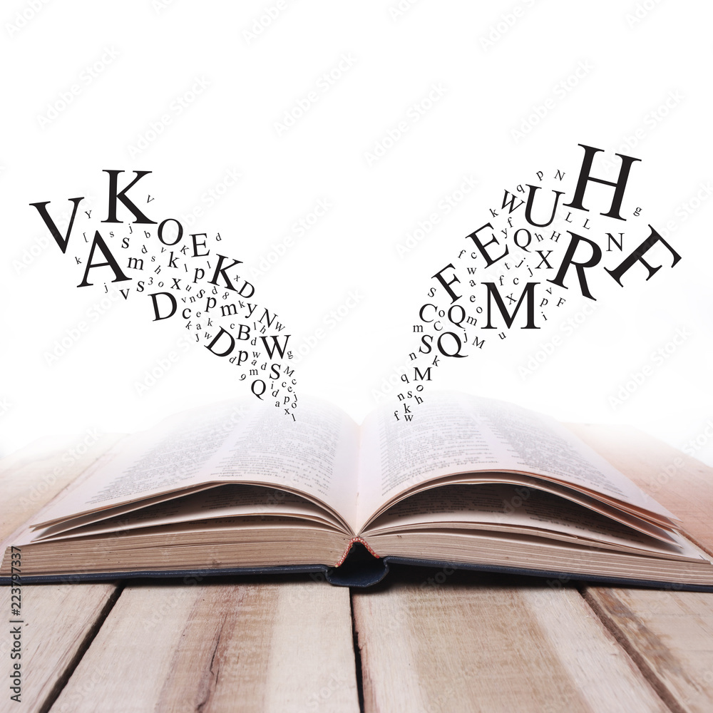 Naklejka premium Opened Book on Wooden Table Against White Background with Letters Flying