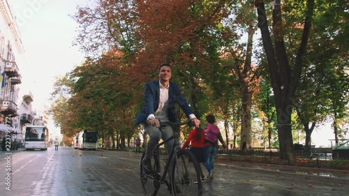Wallpaper Mural Handsome young man driving his bicycle on the street in park in city center during sunrise, slow motion Torontodigital.ca