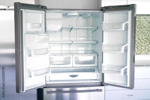 close up on empty refrigerator with door open photo