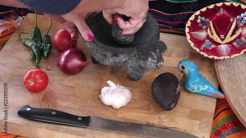 Making mexican salsa in a traditional way with molcajete