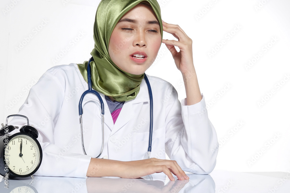 Potrait of stressed young pretty doctor and clock. Overworked concept. Potrait of stressed young pretty doctor and clock. Overworked concept.