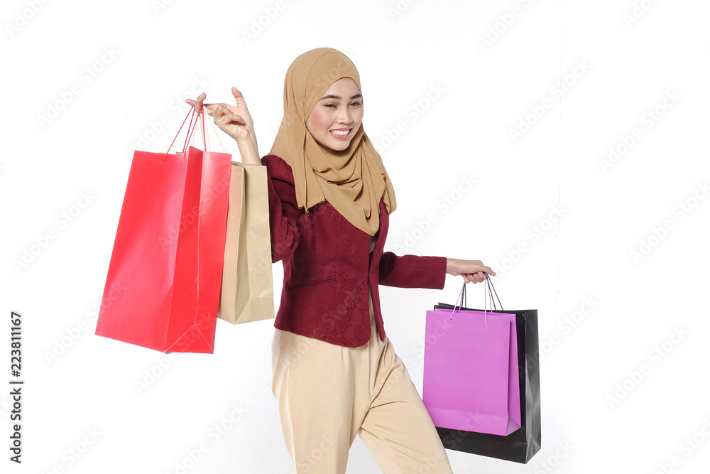 Portrait of a beautiful young muslim woman with shopping bags Portrait of a beautiful young muslim woman with shopping bags