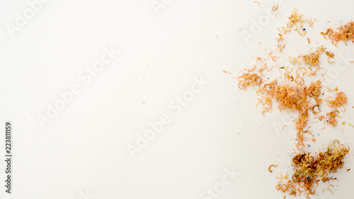pencils placed on the surface with sharpener chips